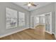 Bedroom with wood floors, windows, a ceiling fan, and glass doors leading to another room at 610 Nadina Pl, Celebration, FL 34747