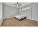 Bright bedroom features a ceiling fan, hardwood floors, and natural light at 610 Nadina Pl, Celebration, FL 34747