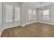 Dining room featuring wood floors, gray walls and double doors to the outside at 610 Nadina Pl, Celebration, FL 34747