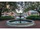 Beautiful three-tiered fountain surrounded by benches and trees, creating a serene public space at 610 Nadina Pl, Celebration, FL 34747