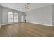 Bright living room with hardwood floors, large windows, and neutral color palette at 610 Nadina Pl, Celebration, FL 34747