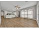 Open concept living room showing wood floors flowing into the kitchen with white cabinetry at 610 Nadina Pl, Celebration, FL 34747