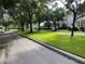 A street view featuring well-manicured lawns, mature trees, and charming homes in the neighborhood at 610 Nadina Pl, Celebration, FL 34747