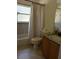 Bathroom with a shower-tub combo, white tile, and a granite countertop vanity sink at 680 Caribou Ct, Apopka, FL 32703