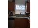 Kitchen sink area with stainless steel appliances, wood cabinets, and bright natural light at 680 Caribou Ct, Apopka, FL 32703