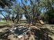 Community park with picnic tables and playground equipment nestled among mature shade trees on a sunny day at 680 Caribou Ct, Apopka, FL 32703