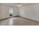 Comfortable bedroom featuring tile floors, ceiling fan, and window overlooking a green lawn at 700 Roby Ct, Dundee, FL 33838