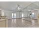 Bright living area with tile floors, ceiling fan, and mirrored wall to enhance the sense of space and light at 700 Roby Ct, Dundee, FL 33838