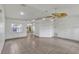 Bright living room with tiled floors and ceiling fan providing a comfortable, welcoming atmosphere at 700 Roby Ct, Dundee, FL 33838