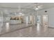 Open living space with mirrored wall, tile flooring, and view into the kitchen at 700 Roby Ct, Dundee, FL 33838