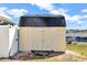 Exterior of a yellow shed with white doors, offering convenient storage space in the backyard at 700 Roby Ct, Dundee, FL 33838