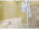 Bright bathroom features a soaking tub with tile surround and a glass enclosed shower at 7624 Bay Port Rd # 40, Orlando, FL 32819