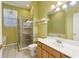 Bright bathroom featuring a glass shower, toilet, and wooden vanity with sink and large mirror at 7624 Bay Port Rd # 40, Orlando, FL 32819