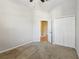 Neutral carpeted bedroom featuring a ceiling fan and closet at 7624 Bay Port Rd # 40, Orlando, FL 32819