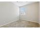 A carpeted room featuring a window with blinds and neutral paint at 7624 Bay Port Rd # 40, Orlando, FL 32819