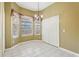 Light-filled dining area showcases tile flooring, bay windows and an elegant chandelier at 7624 Bay Port Rd # 40, Orlando, FL 32819