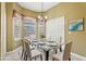 Elegant dining room with a glass table, chandelier lighting, and large windows at 7624 Bay Port Rd # 40, Orlando, FL 32819