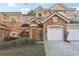 Charming two-story home featuring a stone facade, attached garage, and well-maintained landscaping at 7624 Bay Port Rd # 40, Orlando, FL 32819