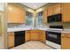 Corner kitchen showing wood cabinets, modern appliances and natural light at 7624 Bay Port Rd # 40, Orlando, FL 32819