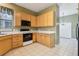 Well-lit kitchen features a corner sink, and modern appliances for a functional cooking space at 7624 Bay Port Rd # 40, Orlando, FL 32819