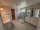 Spacious bathroom with double vanities, a glass-enclosed shower, and tile flooring for a luxurious feel at 780 Pointe Emerson Blvd, Apopka, FL 32703