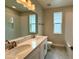 Bathroom with a double sink vanity, white cabinets, and a tiled shower at 780 Pointe Emerson Blvd, Apopka, FL 32703