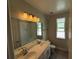 Well lit bathroom with double vanity and tub/shower combination at 780 Pointe Emerson Blvd, Apopka, FL 32703