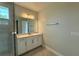 Bathroom featuring a large mirror, single sink vanity, and tiled shower at 780 Pointe Emerson Blvd, Apopka, FL 32703