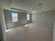 Spacious bedroom with a tray ceiling, recessed lighting, and two large windows for natural light at 780 Pointe Emerson Blvd, Apopka, FL 32703