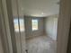 Cozy bedroom with fresh paint and trim and a view through the window at 780 Pointe Emerson Blvd, Apopka, FL 32703
