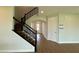 Entryway features staircase with black iron railings and wood-look tile floors at 780 Pointe Emerson Blvd, Apopka, FL 32703