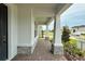 Charming front porch with brick pavers, stately columns, and beautiful landscaping at 780 Pointe Emerson Blvd, Apopka, FL 32703