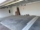 A spacious, unfinished garage presents a clean slate for customization at 780 Pointe Emerson Blvd, Apopka, FL 32703