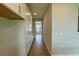 Hallway featuring built-in white cabinets and wood-look tile flooring at 780 Pointe Emerson Blvd, Apopka, FL 32703