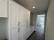 Hallway featuring built in cabinetry and wood-look tile flooring at 780 Pointe Emerson Blvd, Apopka, FL 32703