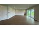 Spacious living room with wood-look tile flooring, recessed lighting, and slider door access to the backyard at 780 Pointe Emerson Blvd, Apopka, FL 32703