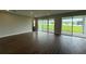 Bright living room featuring wood-look tile flooring, recessed lighting, and sliding glass doors to the patio at 780 Pointe Emerson Blvd, Apopka, FL 32703