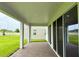 Covered patio with brick flooring, offering a view of the green lawn at 780 Pointe Emerson Blvd, Apopka, FL 32703