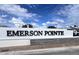 A close-up view of the EMERSON POINTE community sign with clear blue sky and scattered clouds at 780 Pointe Emerson Blvd, Apopka, FL 32703