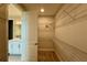 Spacious walk-in closet with shelving and a view into the bathroom at 780 Pointe Emerson Blvd, Apopka, FL 32703