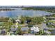 Aerial view of a home in a lakeside community, surrounded by trees and other homes at 9532 Bay Vista Estates Blvd # 1, Orlando, FL 32836