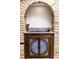 Unique bar area with brick archway and custom-designed cabinet doors at 9532 Bay Vista Estates Blvd # 1, Orlando, FL 32836