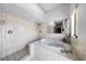 Bright bathroom features a jacuzzi tub, shower, and neutral tile at 9532 Bay Vista Estates Blvd # 1, Orlando, FL 32836