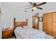 Cozy bedroom with a wood headboard, floral bedding, ceiling fan and closet at 9532 Bay Vista Estates Blvd # 1, Orlando, FL 32836