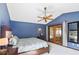 Bedroom with blue walls, and french doors that let in lots of light at 9532 Bay Vista Estates Blvd # 1, Orlando, FL 32836