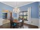 Bright dining room featuring a chandelier, decorative wall art, and hardwood floors at 9532 Bay Vista Estates Blvd # 1, Orlando, FL 32836