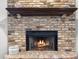 Close-up of a brick fireplace with wood mantle at 9532 Bay Vista Estates Blvd # 1, Orlando, FL 32836