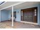 Inviting front porch features a seating area and a dark wood double door entry at 9532 Bay Vista Estates Blvd # 1, Orlando, FL 32836