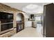 Updated kitchen featuring brickwork, modern appliances, and stainless steel refrigerator at 9532 Bay Vista Estates Blvd # 1, Orlando, FL 32836