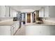 Bright kitchen features white cabinets, stainless steel appliances, and ample counter space at 9532 Bay Vista Estates Blvd # 1, Orlando, FL 32836